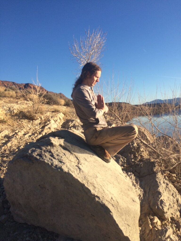 Jonny Wood meditating by a river in Saint George Utah.  